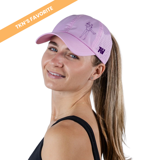 T holding K Ponytail Caps